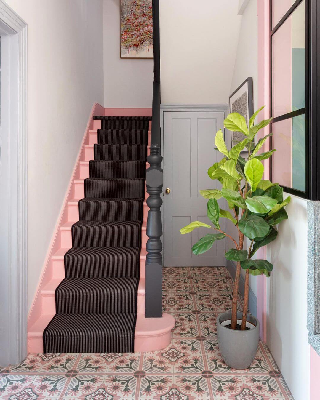 A fiddle leaf fig tree used as the accent color in a renovated hallway