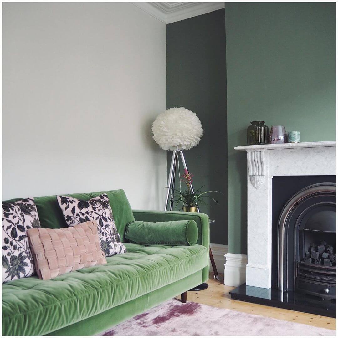 white paint backdrop with green sofa