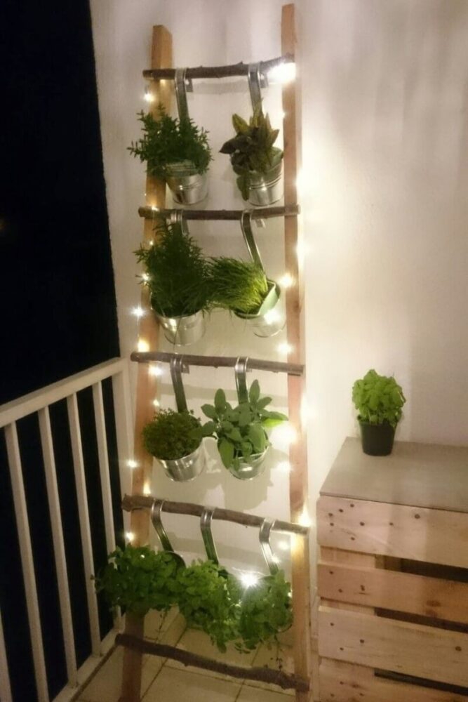 evening ladder garden display with metal pots and lights
