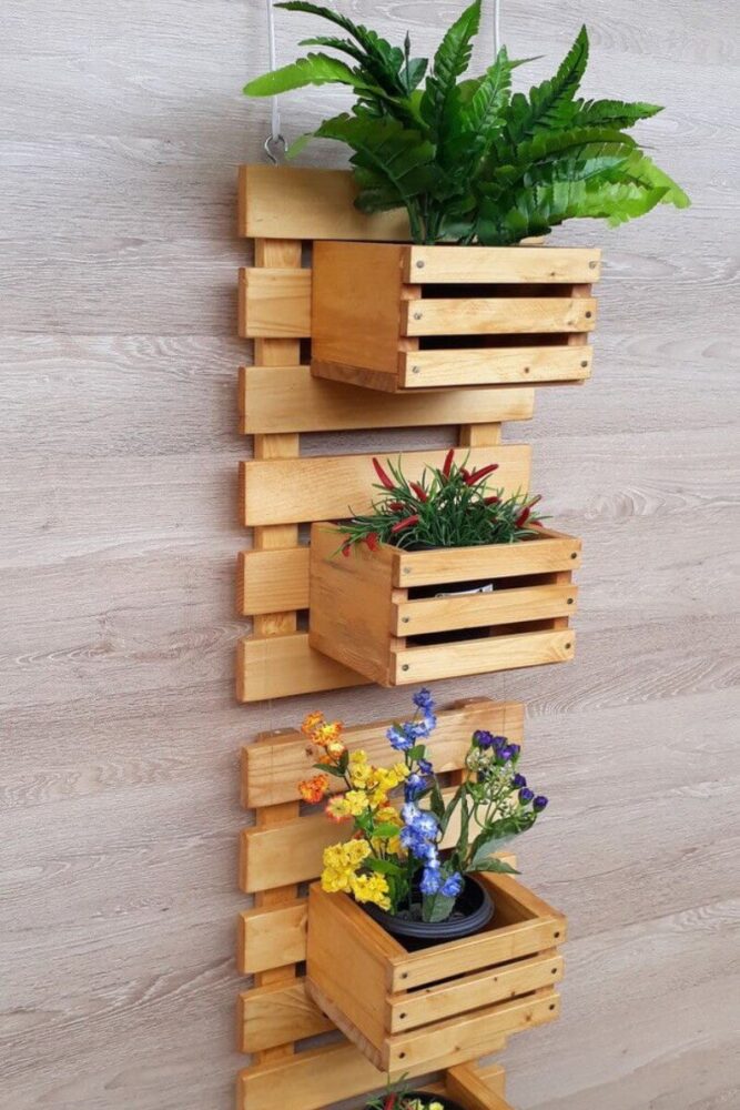 wooden crate vertical garden with flowers against wall